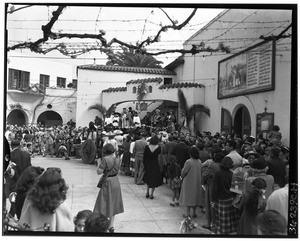 Crowd watching an unidentified religious ceremony on Olvera Street, Los Angeles