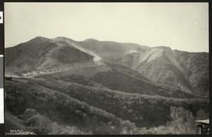 Caravan of cars in a mountain pass, possibly Cramer Canyon and the San Bernadino Mountains, ca.1940