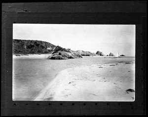 View of Balboa Beach in Corona Del Mar, showing beached sailboat, 1924