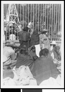 People sitting near a fence in Mexico, ca.1905