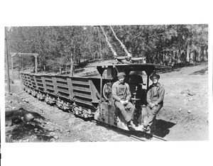 Two men posing on a trolley-line engine for hauling ore cars, Grass Valley, northern California, ca.1900