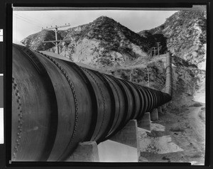 Irrigation pipe on the side of a brush-covered mountain