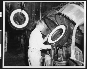 Man making a tire at the B. F. Goodrich Company, ca.1950