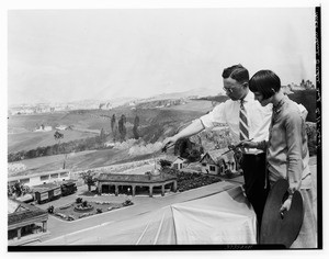 Two artists working on a model of a town