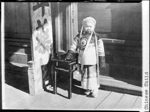 Small Chinese girl in traditional dress, Chinatown, Los Angeles, ca.1920