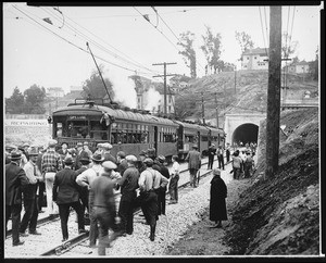 View of the opening of the Hollywood Subway on the Pacific Electric Railway, showing streetcars and onlookers, 1928