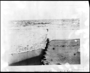 View of waves crashing on a unidentified beach, 1900-1950