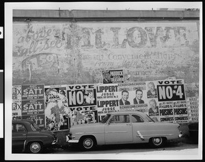 View of election posters covering an old Mount Lowe Railway billboard, Altadena