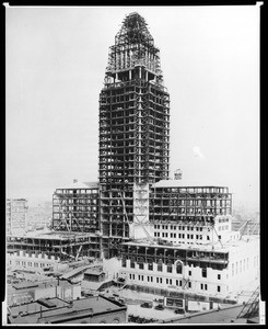 Exterior view of Los Angeles City Hall under construction, showing framework for the entire building, 1928