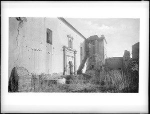 Exterior view of the Mission San Luis Rey de Francia, showing steps and archway, 1887