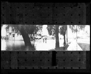 Panoramic view of the flooded intersection of Jefferson Boulevard and Vermont Street, showing wading pedestrians, ca.1898