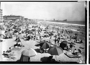 Beachgoers under umbrellas at Venice Beach