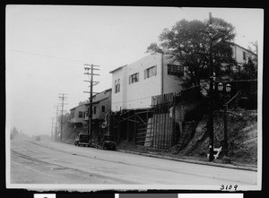 Cahuenga Boulevard after widening with homes perched precariously next to the street, ca.1935