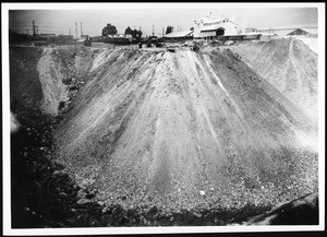 Washington Boulevard roadway fill dump, showing trucks dumping fill, 1939