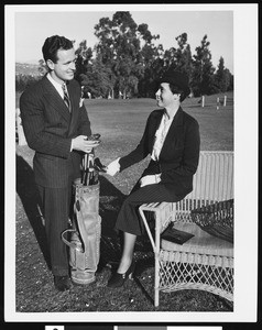 A man and a woman at a golf course, ca.1920