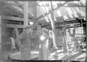 Woman smiling at a factory worker in a factory