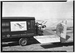 Air Express Service handing packages from a truck to Pilot Maurice Graham, April 13, 1928