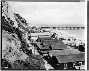 View looking south on the Southern Pacific Long Wharf, or Mile Long Pier, in Pacific Palisades, with the fisherman's village in the foreground, ca.1912