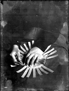 Close-up on the hands of an Indian woman demonstrating basket weaving, ca.1900