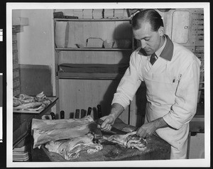 Butcher cutting up meant, ca.1930