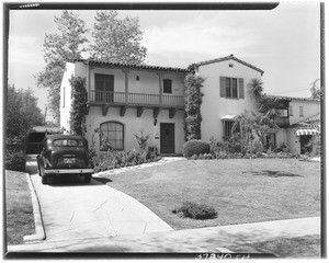 Car in the driveway of a two-story home