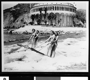 Four water-skiers in Avalon Harbor with the casino in the background