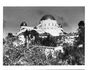 Exterior view of the Griffith Park Observatory, showing a house in the foreground, 1910-1940