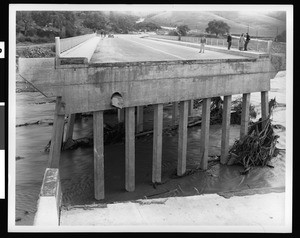 People at the end of a flood damaged bridge, possibly at the Warner Brothers-First National Studios, 1938