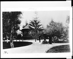 Man and a woman standing in front of a bandstand in Pershing Square in Los Angeles, ca.1890