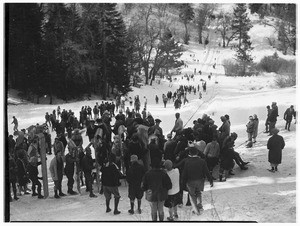 People waiting at the bottom of a hill to toboggan at Big Pines