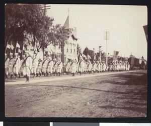 Men in uniform marching in a parade, ca.1900