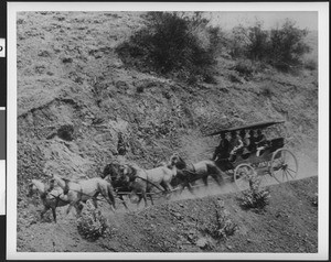 Stage coach and horses on a mountainous dirt road, ca.1900