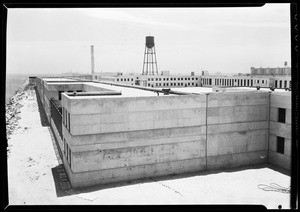 Exterior view of the Terminal Island federal prison showing a water tower behind the building