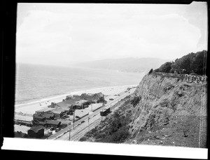Birdseye view of Santa Monica Beach looking north from Palisades, showing houses, ca.1920
