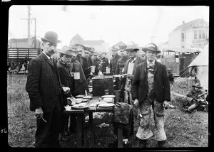 Refugees eating at the camp of First Coast Battery Artillery, San Francisco, 1906