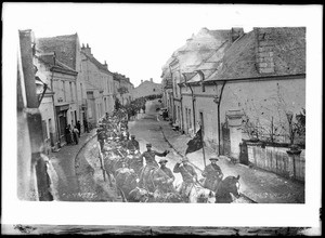 American soldiers passing through the narrow street of a French village on the way to the front, ca.1915