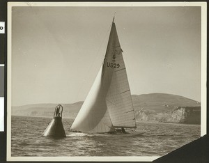 Sailboat beside a metal buoy, ca.1940