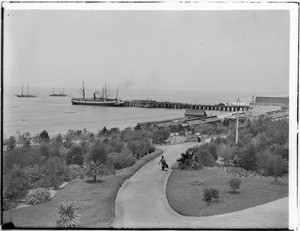 View of Redondo Beach Pier and railroad station from the Redondo Hotel, whose garden is also seen, ca.1900