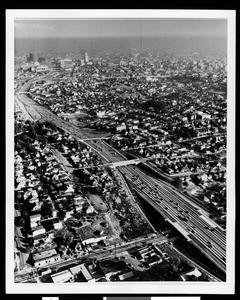 Aerial view looking down a Los Angeles freeway, showing the area adjacent to City Hall, ca.1950-1959