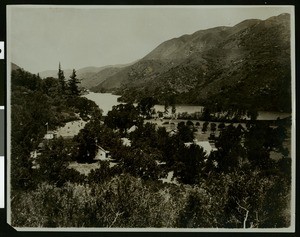Homes and mountains surrounding a lake in Lake County, ca.1910