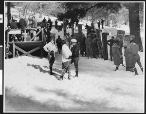 People carrying their toboggans in the snow, ca.1930