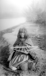 Mojave Indian woman making a beadwork belt with heart-shaped designs, ca.1900