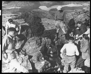 A close-up view of mountain climbers examining Pre-Cambrian Rocks near Sierra Pelona Lookout, ca.1930