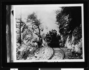 Mount Lowe Railway car with Professor Thaddeus S.C. Lowe passing through Granite Gate