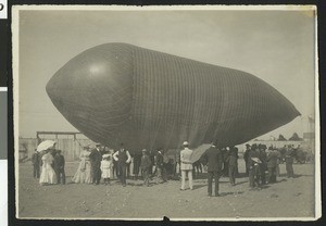 "Frisbie's dirigible" tied to the ground with spectators around it, ca.1905
