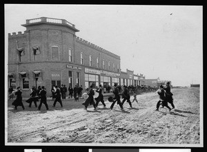 Musical band called The Minstrels playing across the street near the Valley State Bank, El Centro, ca.1910