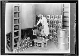 Containers being filled with "Oil of Lemon", ca.1925