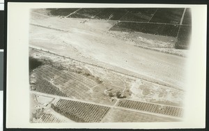 Aerial view of flooding of the Santa Ana River near Colton, showing a break in the levee near Santa Ana, ca.1930