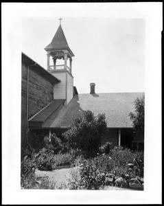 View of the bell tower at Mission San Luis Obispo from the patio, ca.1900