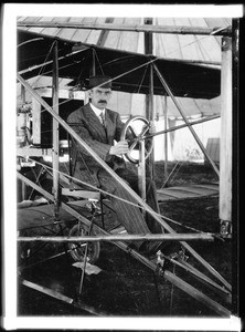 Aviation pioneer Glenn Curtiss at the wheel of an airplane at Dominguez Field, ca.1912